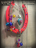 Sacred Rio is also is accented with some vintage 70's bright colored baubles in blues, yellows, red and purple and surrounded by multi color Swarovski crystals in green, blue and red